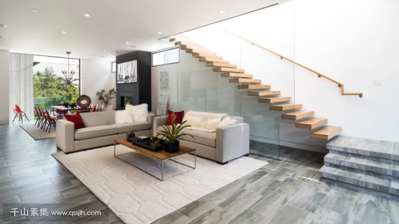 07-The-floors-are-covered-with-grey-and-beige-tiles-and-the-staircase-is-exciting-of-wood-and-glass-looks-very-modern-775x436.jpg