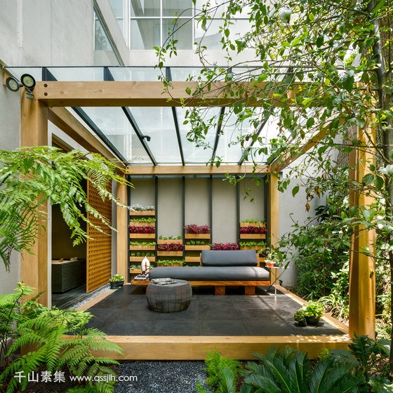 03-This-is-one-of-the-terraces-with-a-vertical-garden-and-a-modern-Asian-like-bench.jpg