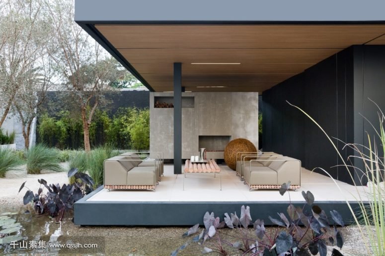 10-Theres-a-roofed-terrace-with-a-fireplace-chairs-and-a-table-for-inviting-family-and-friends-775x517.jpg