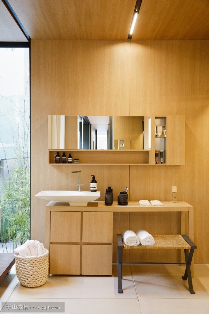 07-The-bathroom-features-the-same-materials-and-comfy-furniture-with-everything-necessary.jpg