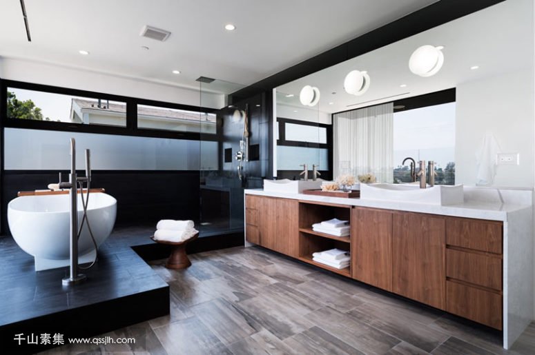 09-The-master-bathroom-is-done-in-warm-woods-and-black-tiles-looks-very-chic-and-laconic-775x515.jpg