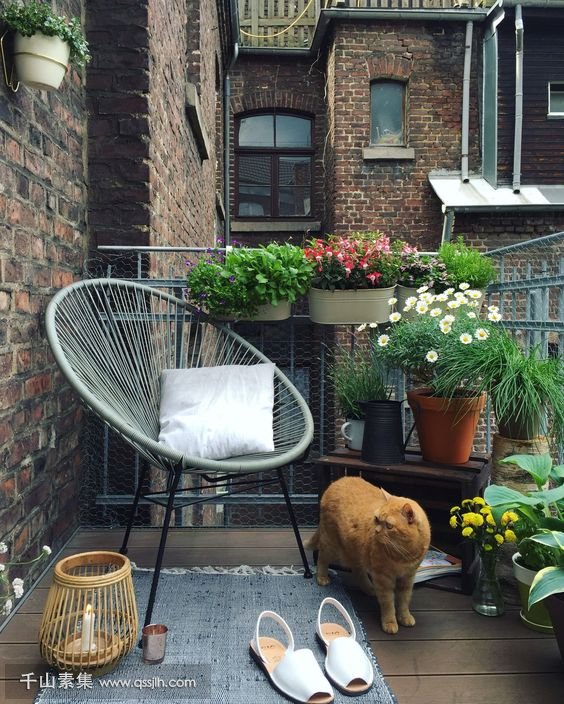 22-a-summer-balcony-with-potted-greenery-and-blooms-a-chair-a-rug-and-candles.jpg