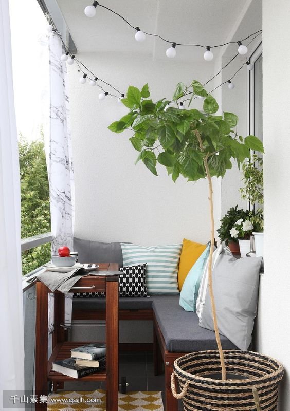 21-a-small-cozy-balcony-with-an-L-shaped-upholstered-bench-a-small-coffee-table-and-potted-plants.jpg