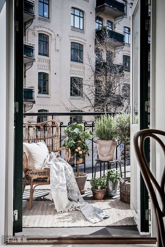 20-a-small-balcony-with-a-wicker-chair-potted-greenery-and-baskets-for-storage.jpg