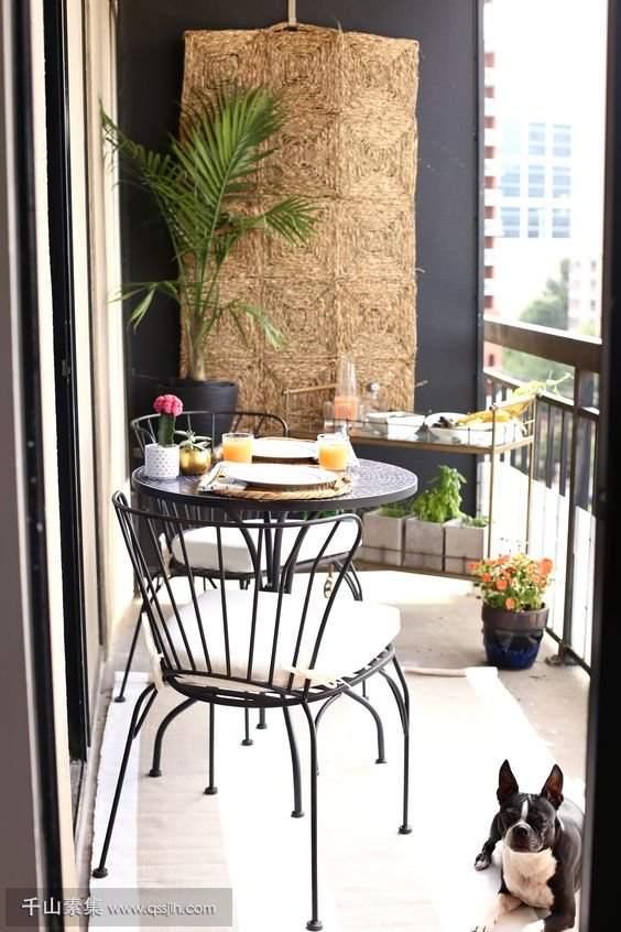 12-a-round-table-comfy-forged-chairs-a-stand-with-plants-and-dishes-on-top-a-jute-hanging-on-the-wall.jpg