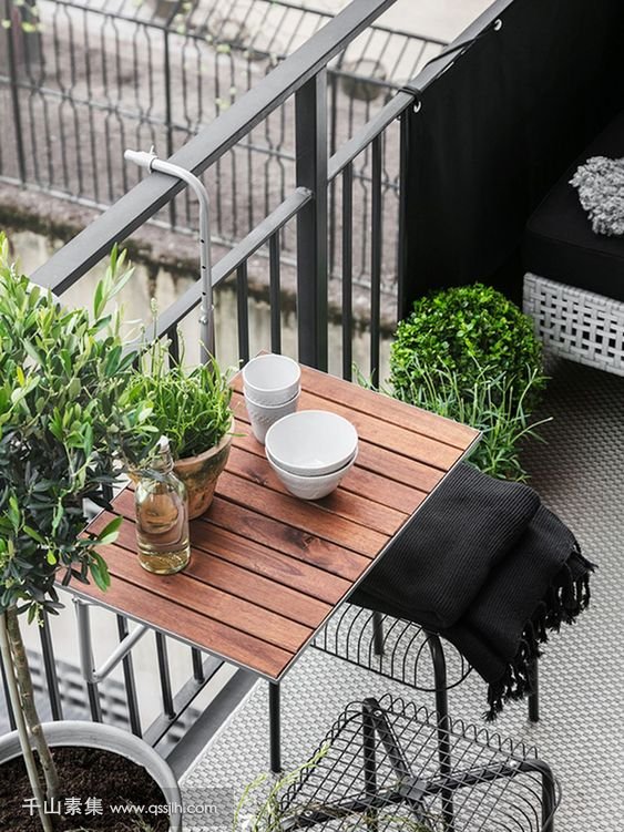 10-a-hanging-table-metal-chairs-and-a-wicker-seat-plus-potted-greenery-for-a-lively-modern-look.jpg