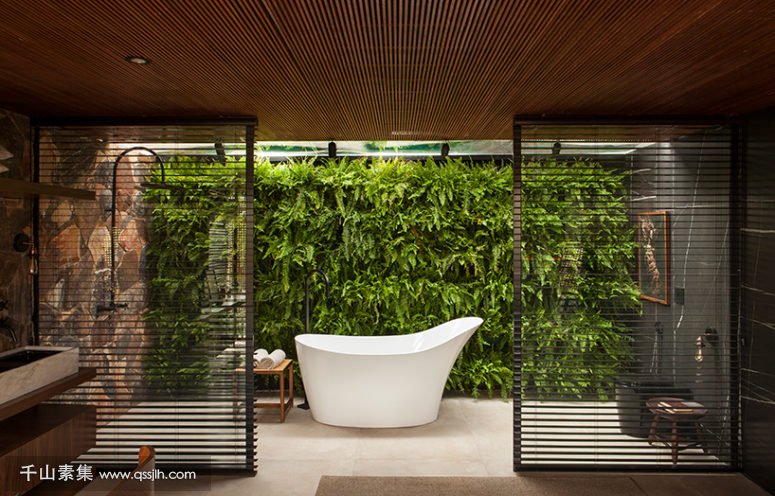 04-The-bathroom-also-features-a-gorgeous-living-wall-and-wooden-screens-to-divide-the-sink-zone-from-the-bathing-one-775x496.jpg